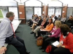 John Manzoni listening to delegates of the 2015 academy