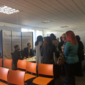 Interested attendees crowd around an infornation stand