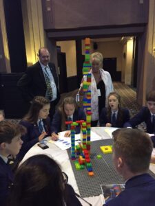 Children building a tower made of building blocks