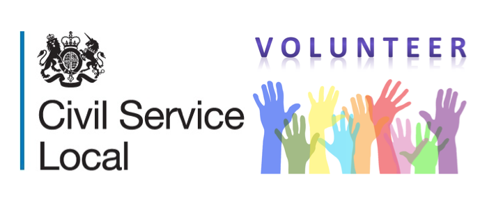 Different coloured hands pointing up to the word volunteer