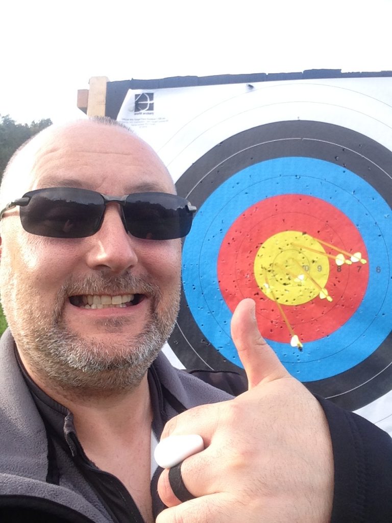 Paul gives a thumbs-up by an archery target