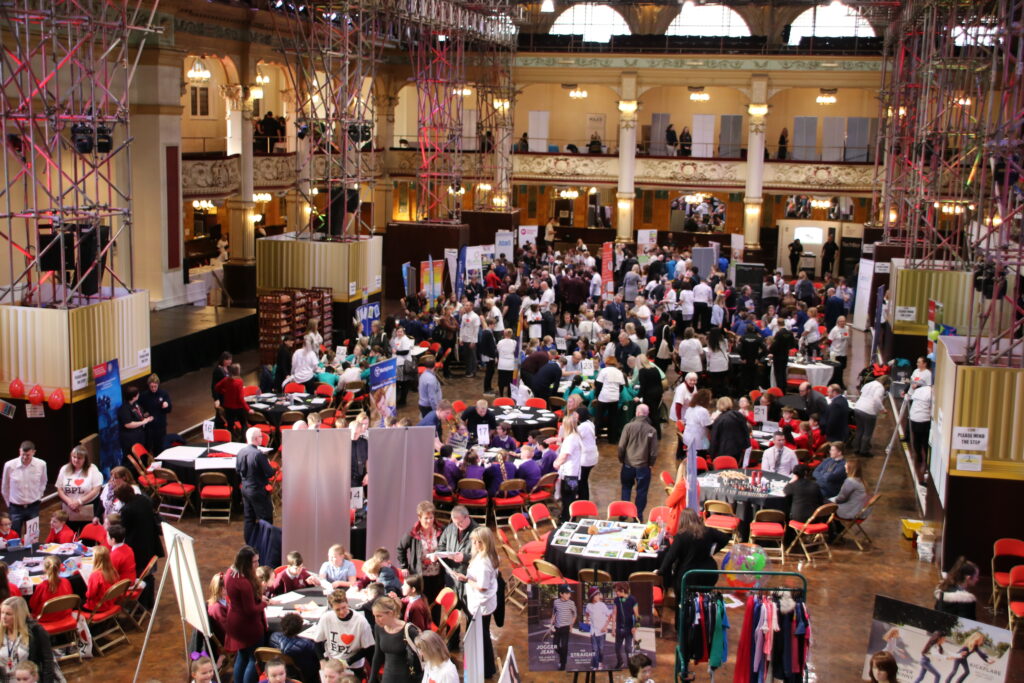 Busy display stands and activity tables in the main hall