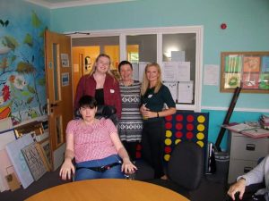 Group of four people, one in wheelchair