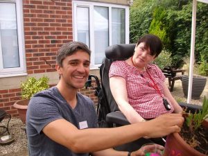 Man crouching talking to lady in wheelchair