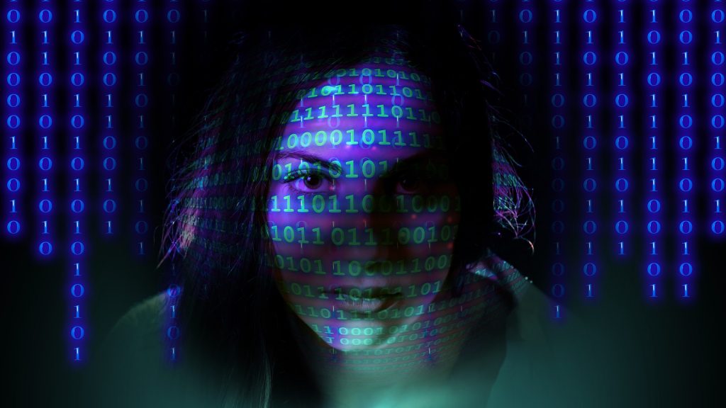 Woman's head overlaid with binary numbers