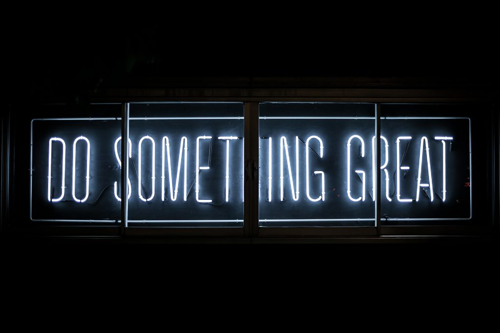 A neon sign saying "Do Something Great"