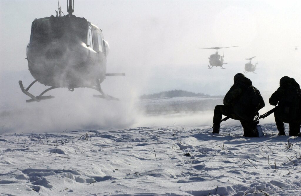 helicopter coming into land near soldier