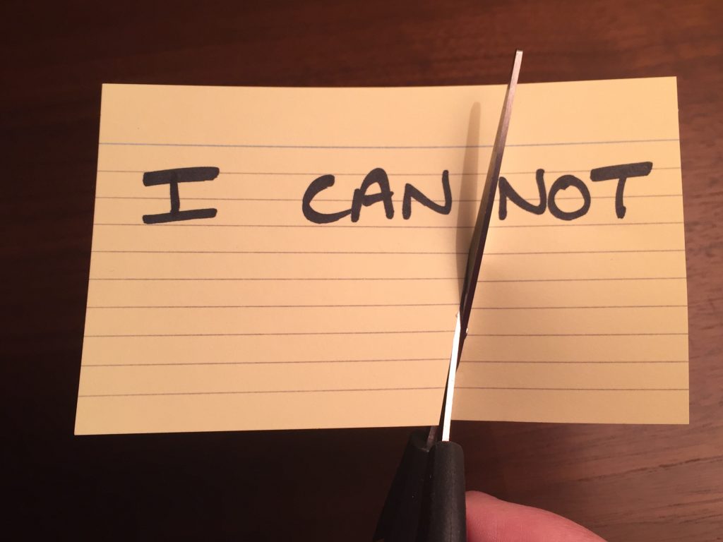 Image shows the words I CAN NOT, with a pair of scissors cutting off the word NOT.
