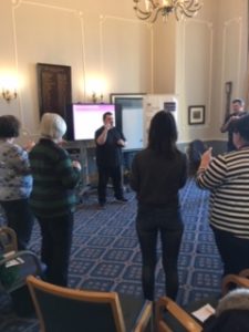 People stood in room using sign language