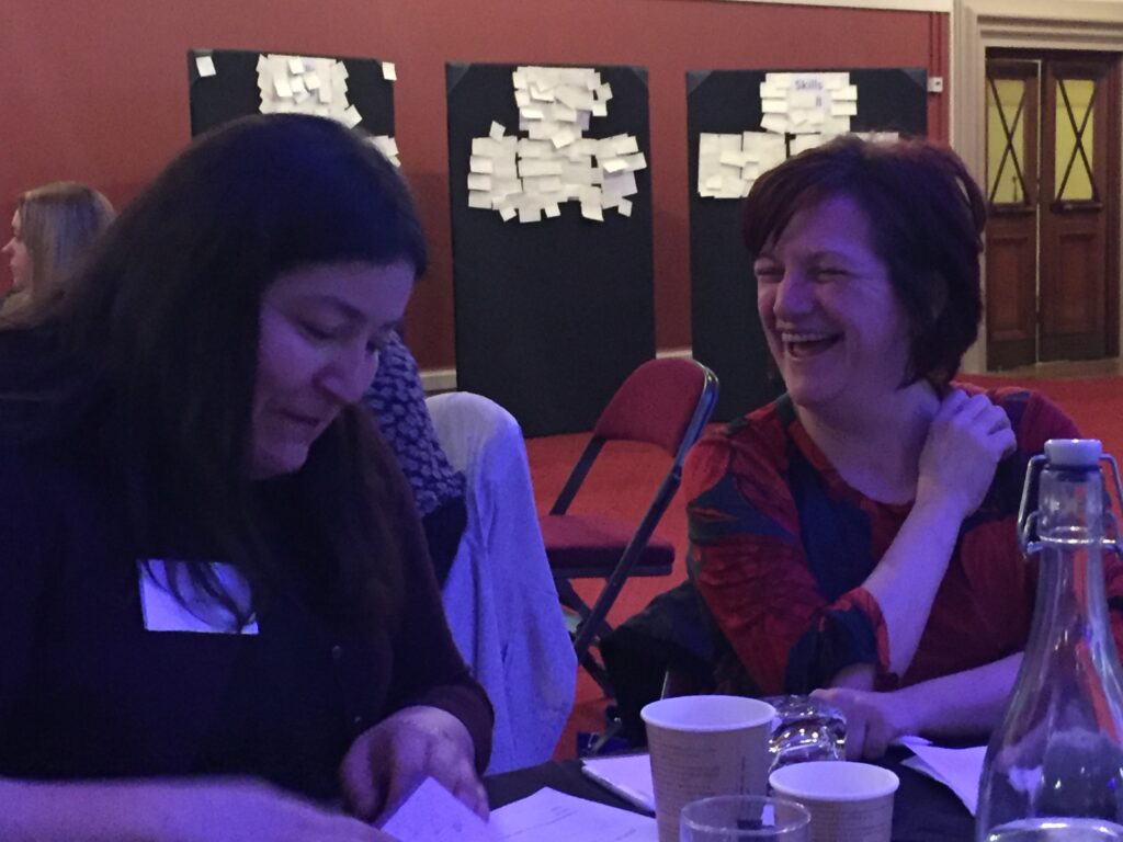 Two people laughing at a table