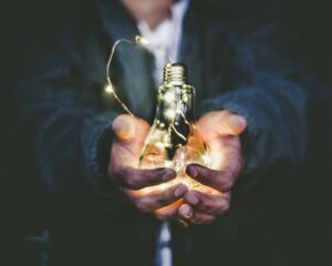 Hands holding a light bulb 