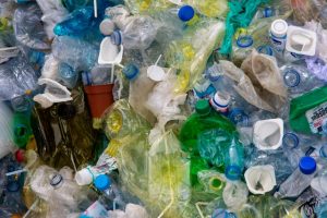 A pile of crushed used plastic bottles in different colors