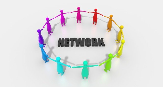 Multicoloured people shaped pegs forming circle around the word Network