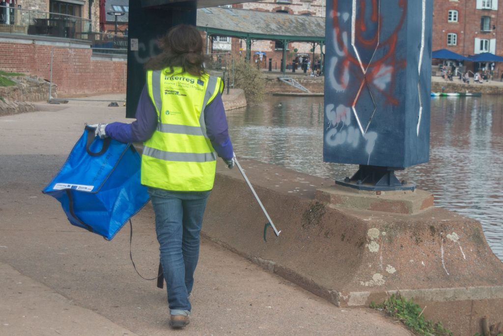 person picking up litter